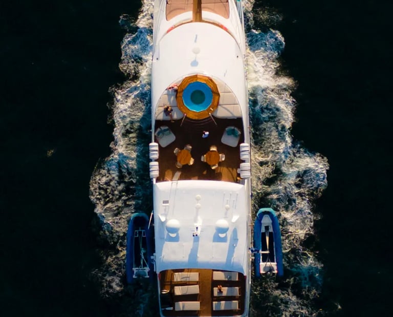 Luxury expedition yacht navigating pristine ocean waters, offering boutique cruise experiences