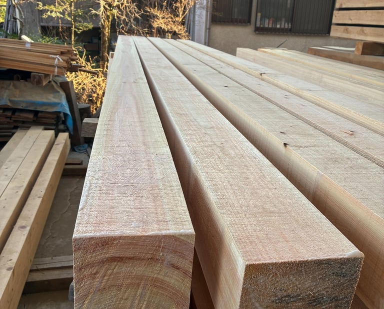 Stacked square hinoki cypress flitches in a lumber yard for construction and carpentry.