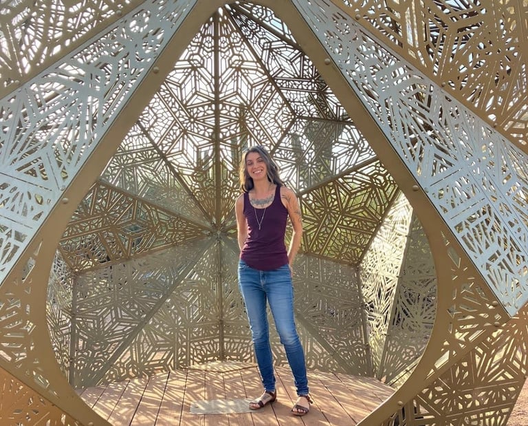 a photo of Danielle in an interactive geometric art sculpture