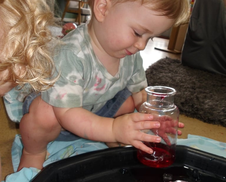 child playing with a jar