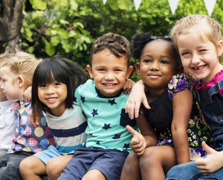 a group of children sitting on a bench