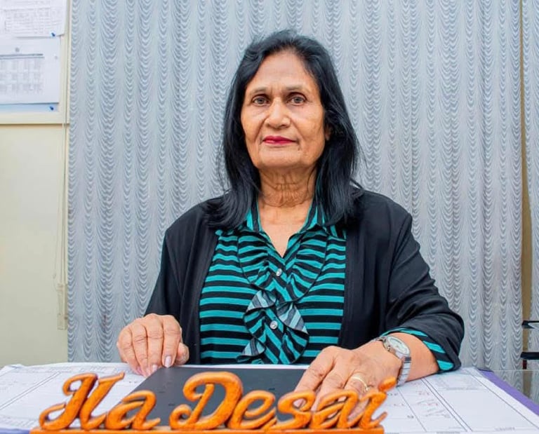 a woman sitting at a table with a sign that says he's done