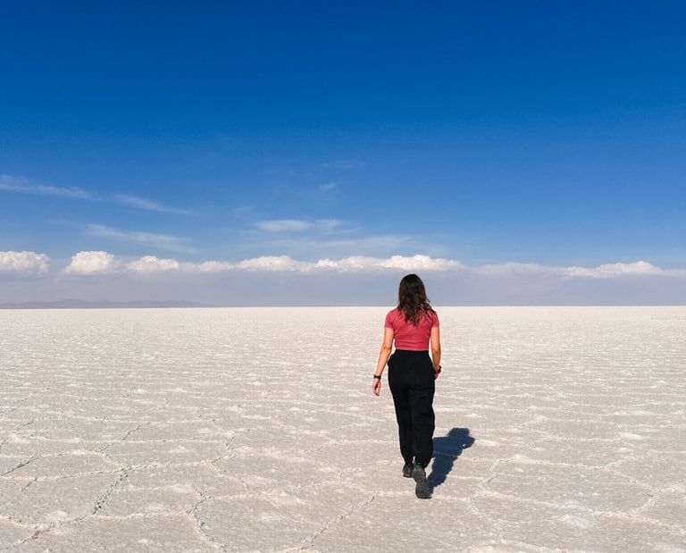 Girl in Salar de Uyuni, salt desert in Bolivia, South America