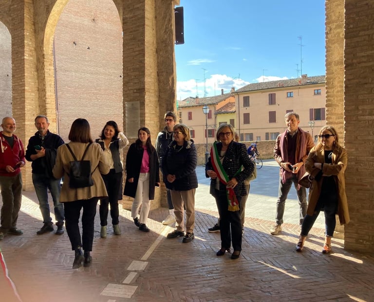 a group of people standing in a line of arches