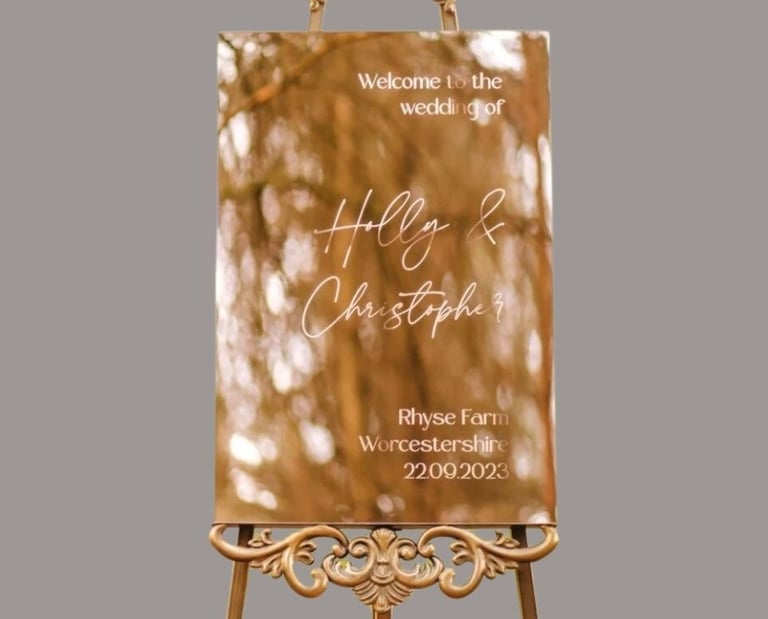 gold mirror sign for holly and christopher