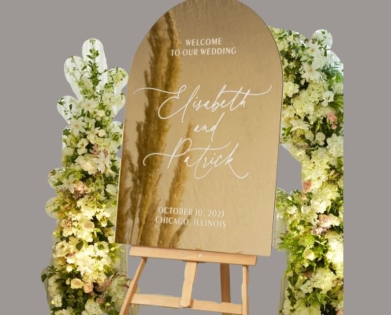gold arch mirror sign of elisebeth and patrick