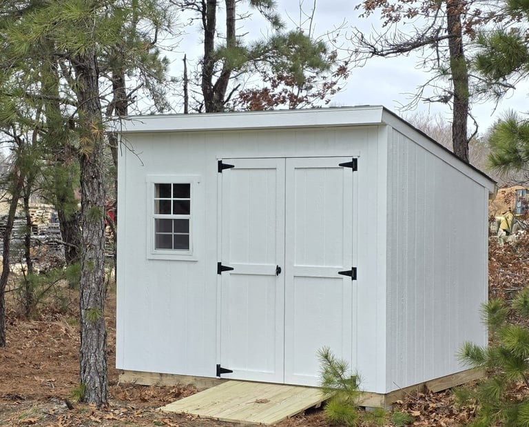 Custom-built 6x8 wooden shed with window, handcrafted in Halifax, Massachusetts for small outdoor spaces.