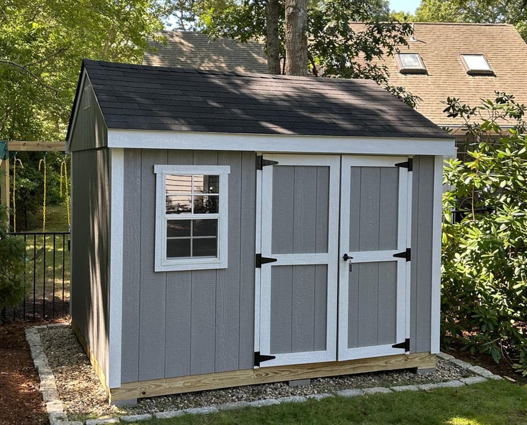 Custom 8x10 wooden shed with double doors and window, built in Halifax, Massachusetts for functional backyard storage.