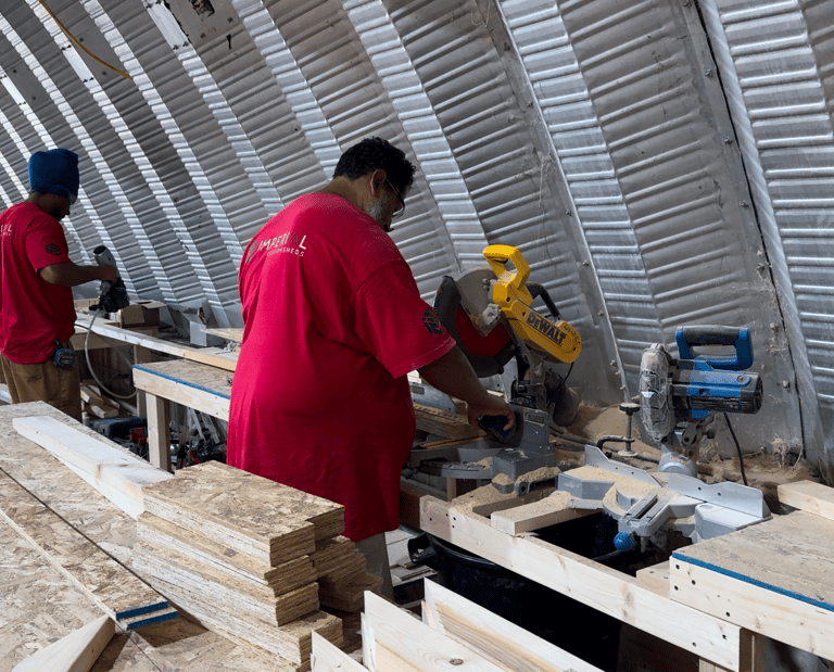 Imperial Custom Sheds crew fabricating custom shed components in workshop