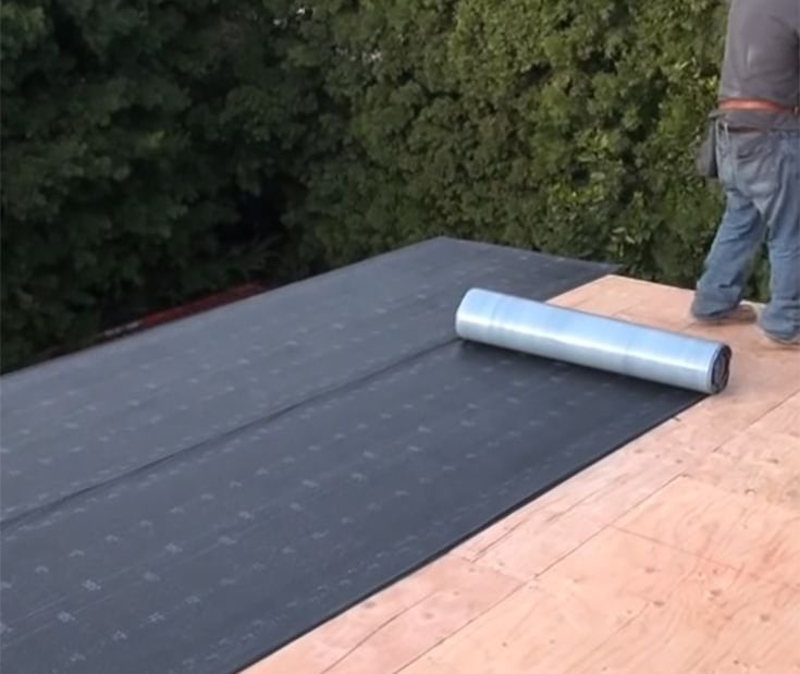 Waterproof roofing tar paper installed on Massachusetts-built shed for durable weather resistance.