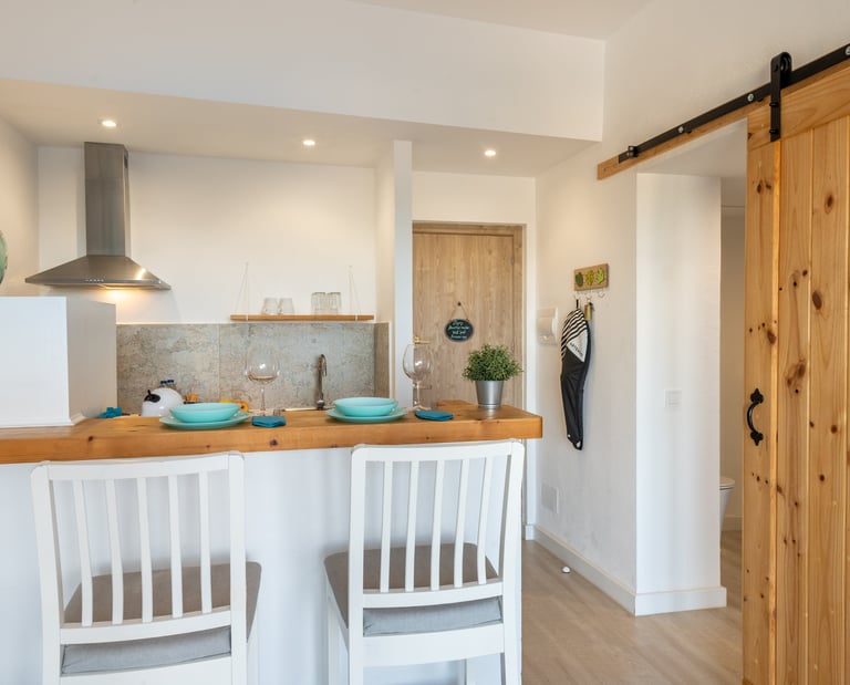 kitchen with American-style bar table and high wooden chairs