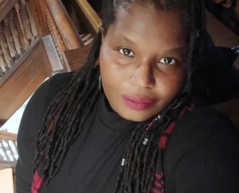 a woman with dreadlocks and a black shirt