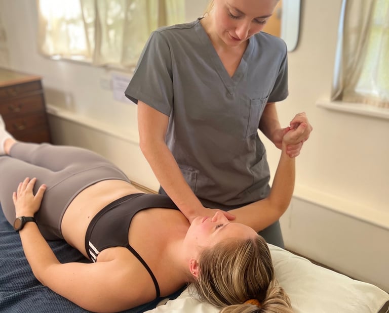 osteopath assessing patient and providing treatment in clinic room