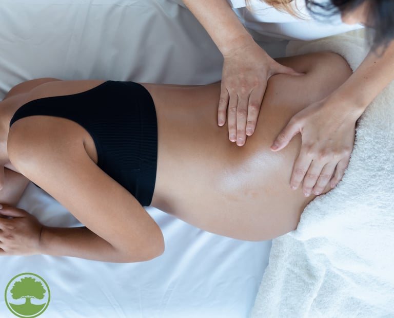 pregnant woman being massaged by massage therapists 