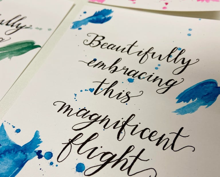 calligraphy lettering in black ink on a white background with blue painted birds