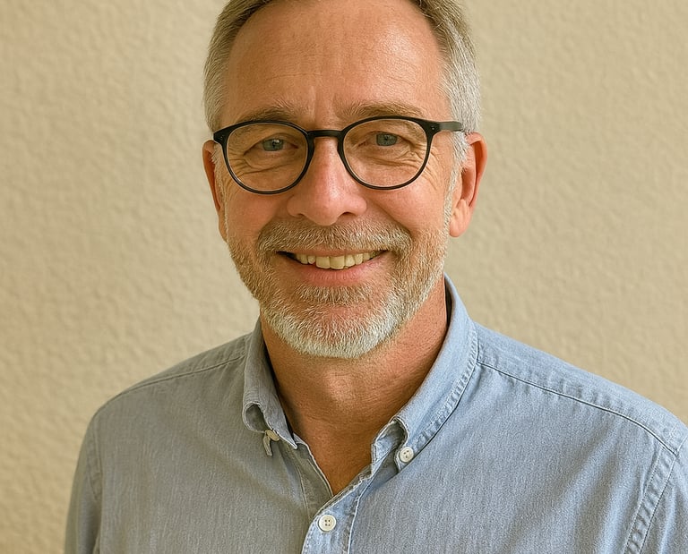 a man with glasses and a blue shirt