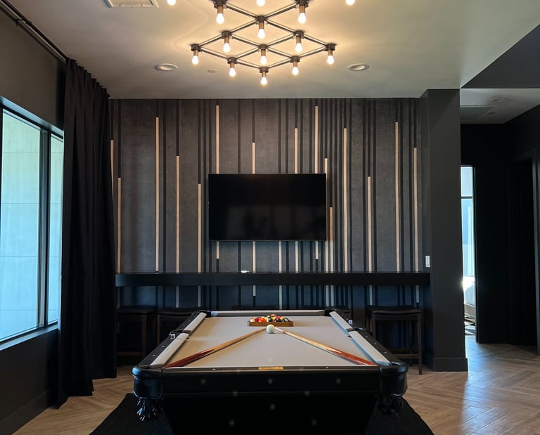 Modern accent wall featuring black, gold, and gray vertical wood slats against gray limewash