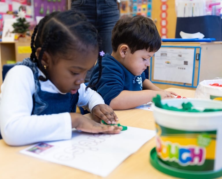 PreK students using playdough mats to develop fine motor skills.