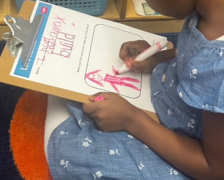 PreK students reflects on an OOPA worksheet.