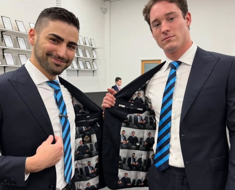 two men in suits and ties posing for a picture