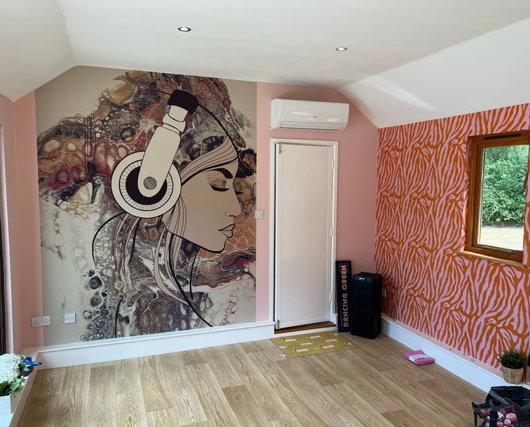 Feature wall wallpaper installation with bespoke mural and wood flooring in a Brighton home