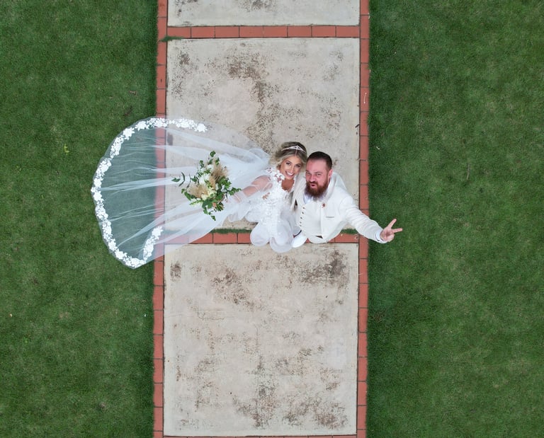 a bride and groom standing on a path