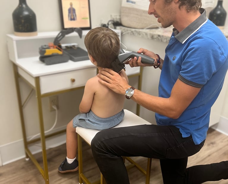 Franklin chiropractor doing insight scans on a small child to find subluxations