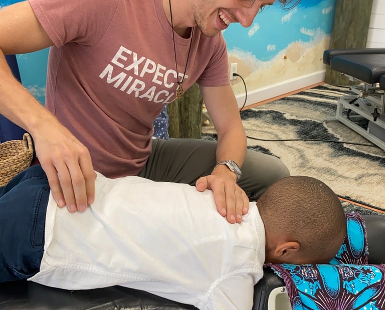 Young child getting adjusted by Franklin pediatric chiropractor
