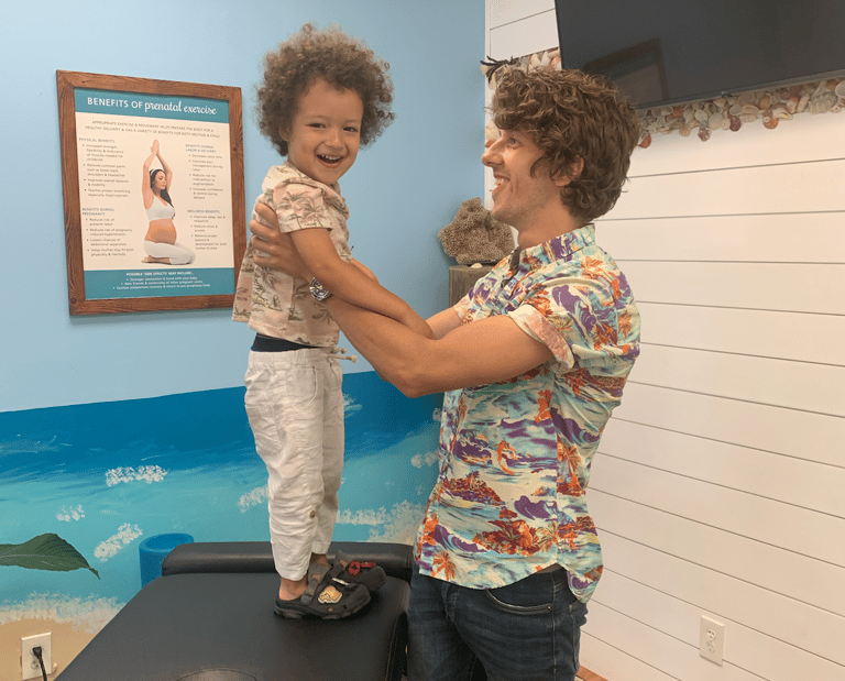 Child relaxed and smiling during pediatric chiropractic visit in Franklin Tn