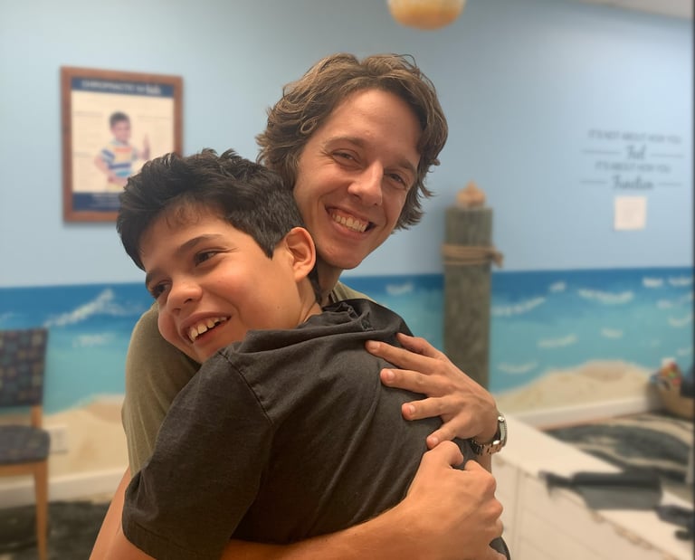 Chiropractor working with special needs to help with speech and motor delays