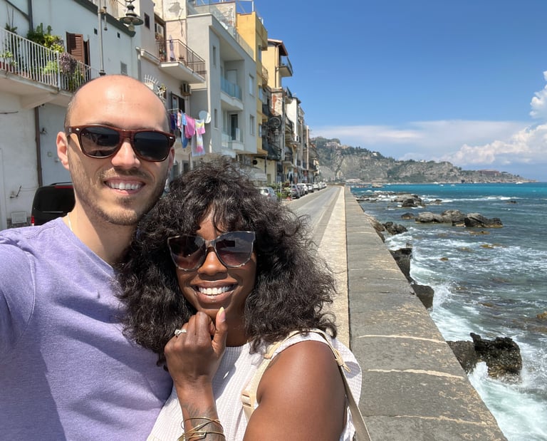 a man and woman taking a selfie with a camera