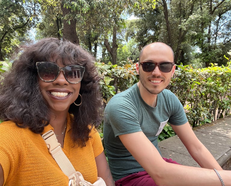 a man and woman sitting on a bench in a park