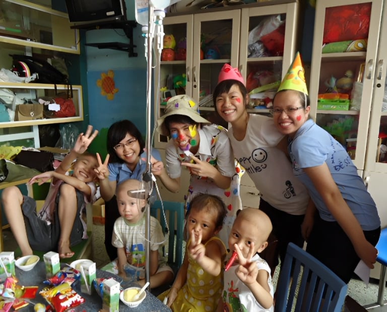 a group of people standing around a table with cake