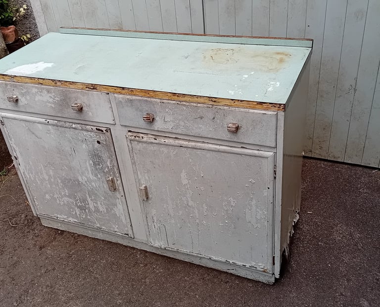 Dilapidated cupboard with peeling white paint