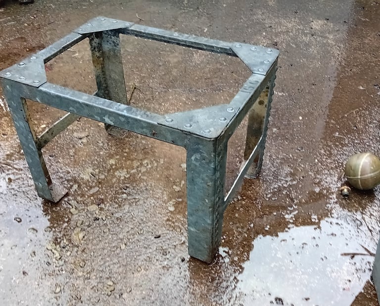 The sides and base of the tank have been cut away to leave 4 legs with cross bars and the top edges