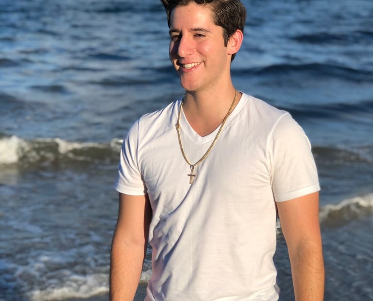 Rene Aviles in a white shirt and black pants