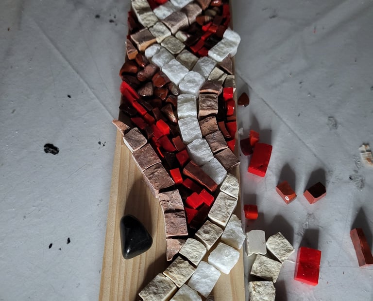 a wooden cutting board with a mosaic tile pattern