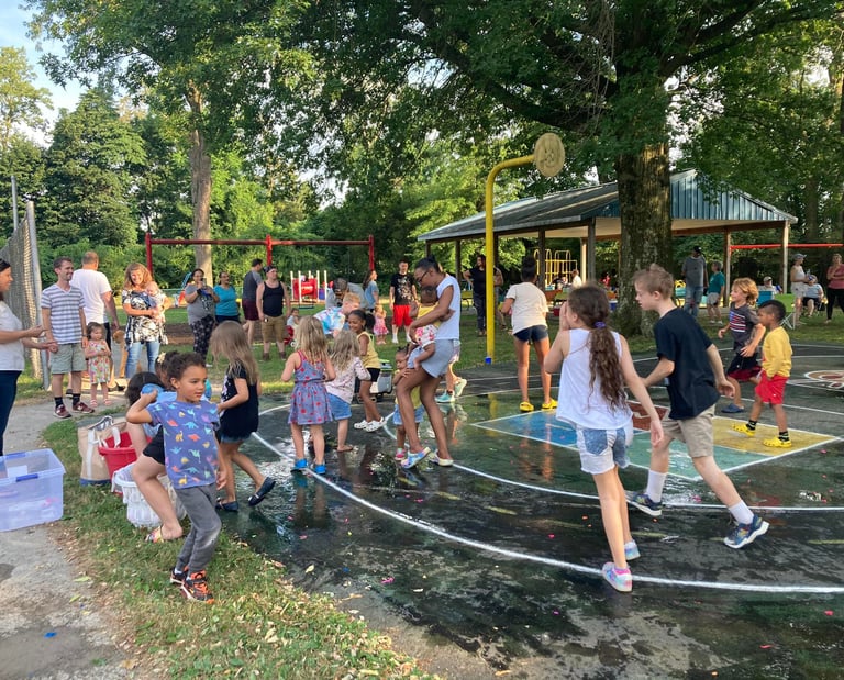 Children in a water balloon fight at Crescent Hills Park
