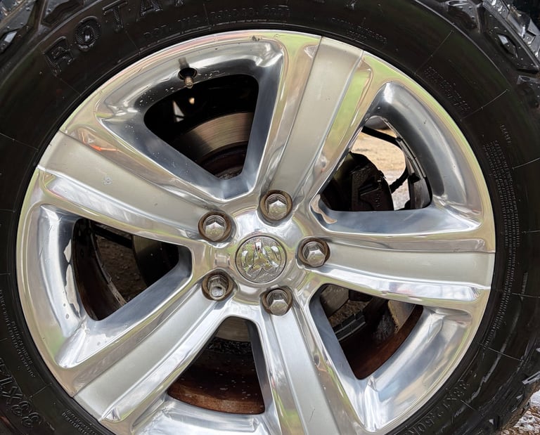 Close-up of a silver five-spoke Ram truck detailing to perfection by mobile detailers