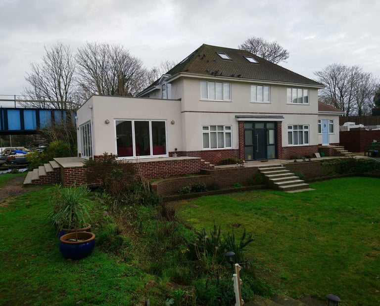 Orangery and single storey extension. With terrace overlooking a river.