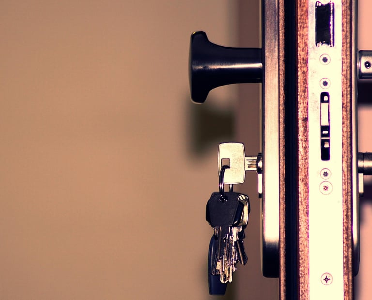 a key chain with a key in a lock on a door