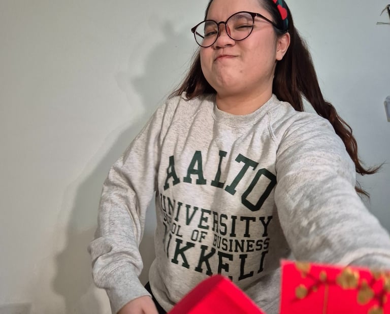 a woman in a grey Aalto university sweater