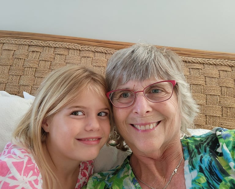 Teresa Wood-Hansen smiling next to her granddaughter Mary Grace 