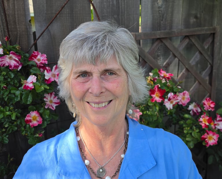 Portrait of Teresa Wood-Hansen with beautiful pink flowers in the background