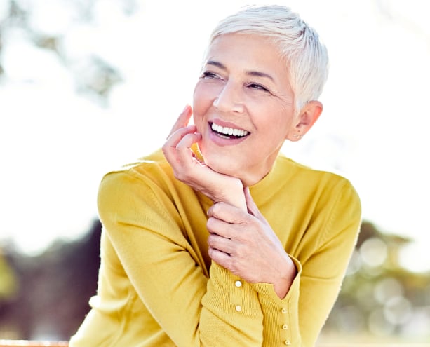 Older woman smiling because holistic support helps recovery after cancer treatment