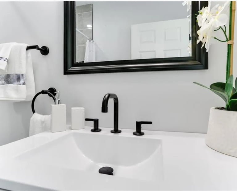 Modern bathroom vanity with matte black fixtures and added storage