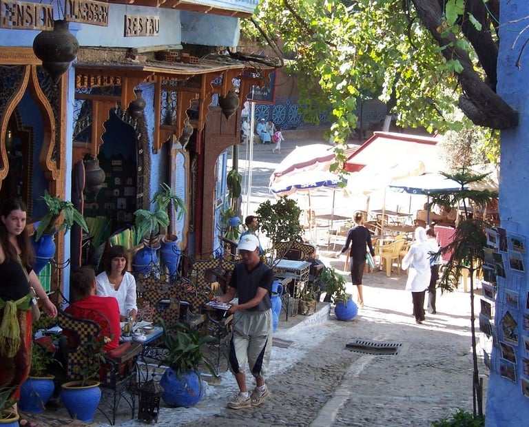 morocco chefchaouen a group of people walking down a street