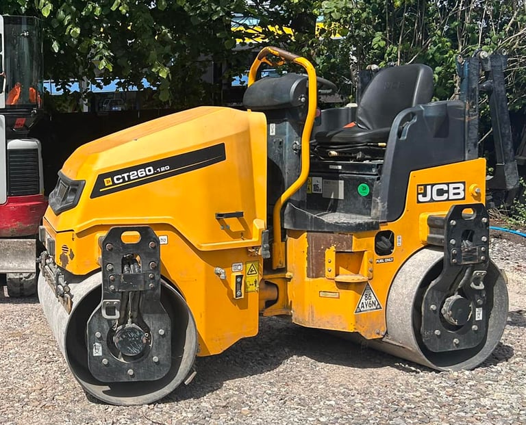Twin-drum roller hire compacting surface on a new driveway in the West Midlands