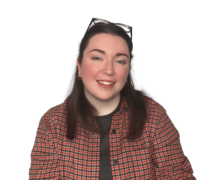 A women (Erin, owner of EB Socials) with brown hair and an orange checked shirt, smiling at the camera