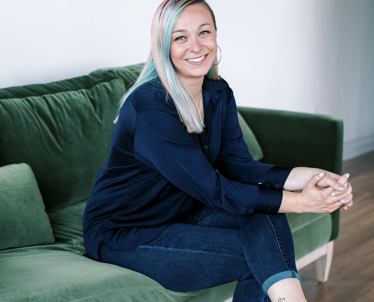 Tabitha with butterfly effect consulting sitting on a couch with her feet on the floor